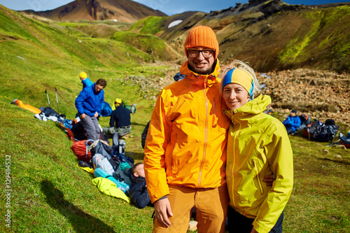 Couple of friends tourists traveling on vacation, hiking in Iceland. smiling friends hugging and posing