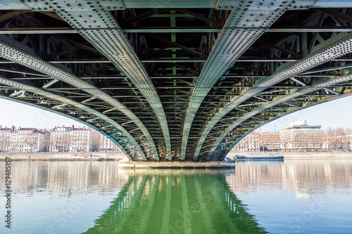 Under a bridge with a river