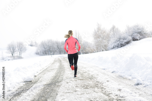 Fitness running woman in winter season