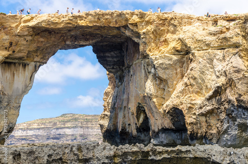 Tourists on the Azure Window in Gozo, Malta photo