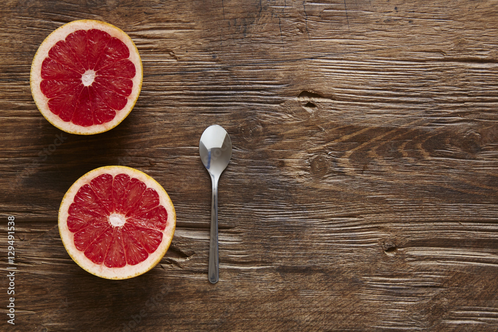halfed organic grapefruit and spoon ready to eat