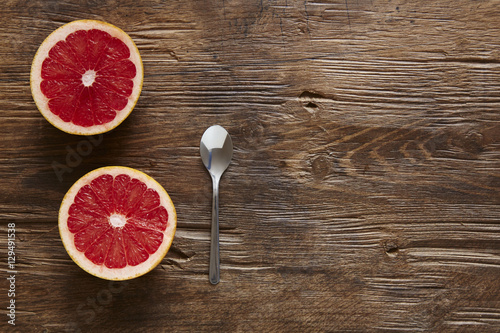 Fototapeta Naklejka Na Ścianę i Meble -  halfed organic grapefruit and spoon ready to eat