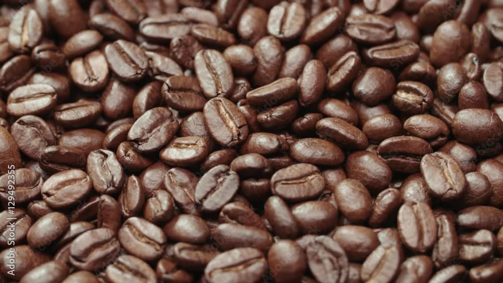 beautiful background of roasted coffee beans rotating in slow motion beautiful background of roasted coffee beans rotating in slow motion