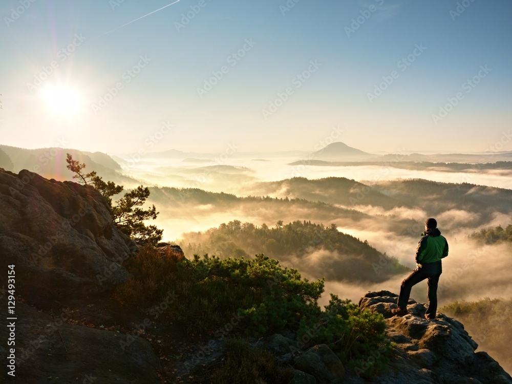 Man silhouette stay on sharp rock peak. Satisfy hiker enjoy view.