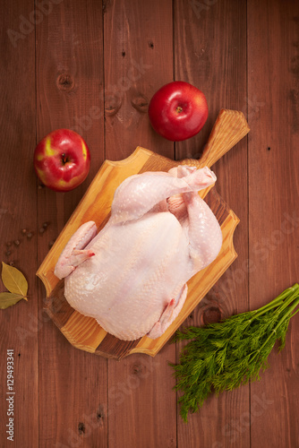 Fresh chicken on a wooden table