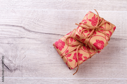 Gift paper wrapped boxes. Present boxes with rope bow. Prepare gifts for beloved people. Happiness all around.
