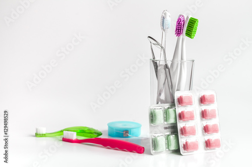 toothbrushes in glass on white background tools for oral care