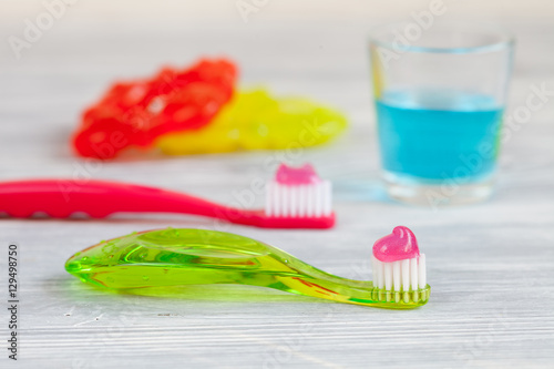 children s toothbrush oral care on wooden background