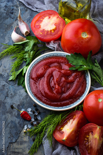 Tomato ketchup sauce on concrete background
