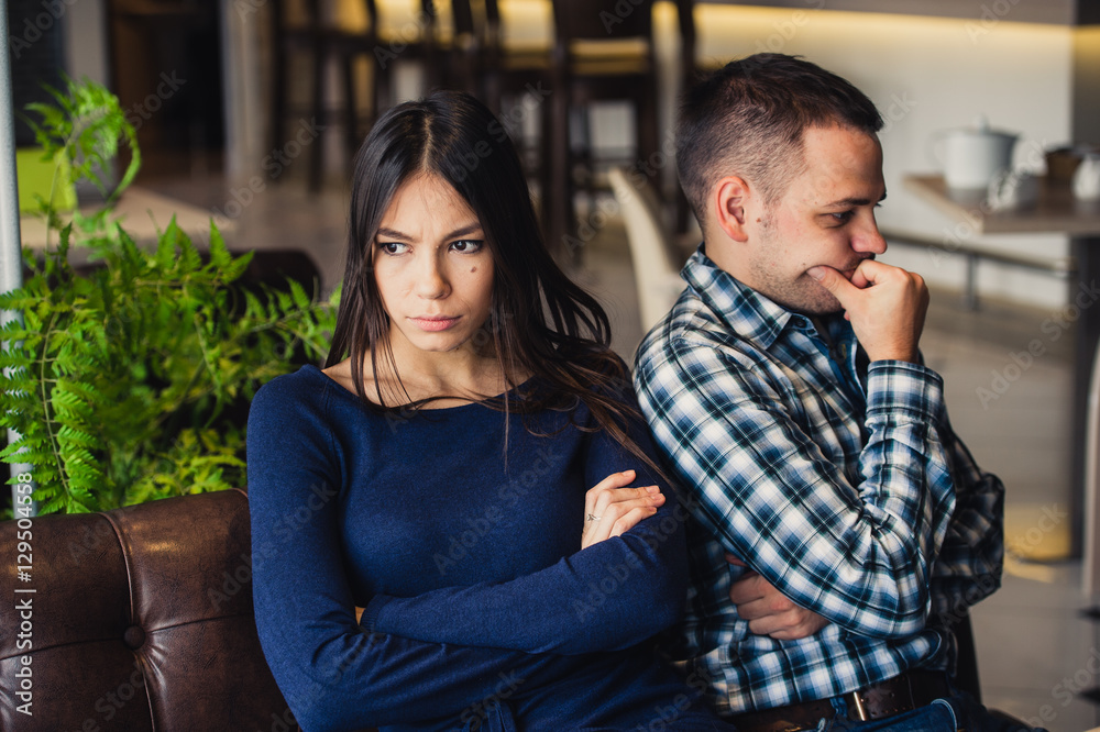 Couple at cafe during lunch. They are taking offense and sitting back Couple at cafe during lunch. They are taking offense and sitting back
