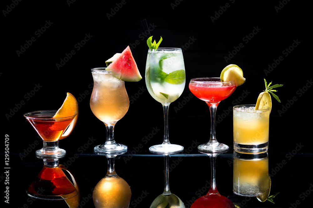 Cocktails alcoholic drinks selection mojito on black background with reflection