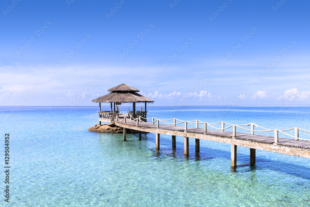 Pier in tropical turquoise clear water, beach travel destination