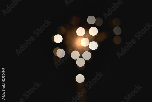 Light blur and defocus bokeh circles on black sky background