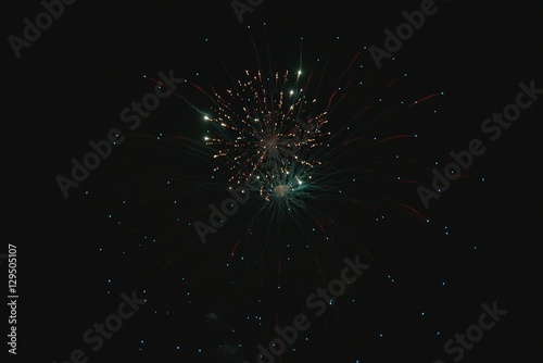 Shiny natural fireworks on dark sky background with little smoke