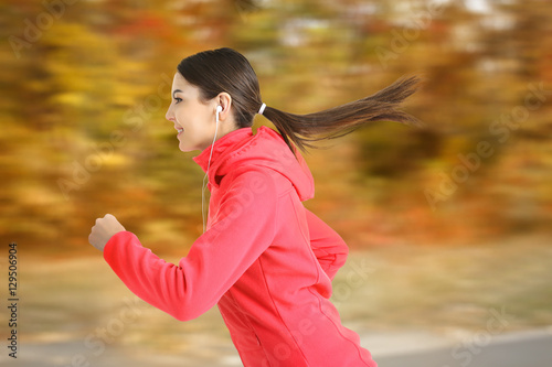 Young woman running at part...