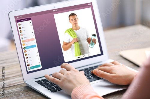 Woman video conferencing wi...