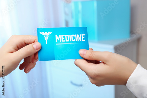 Medical service concept. Female hand giving visiting card