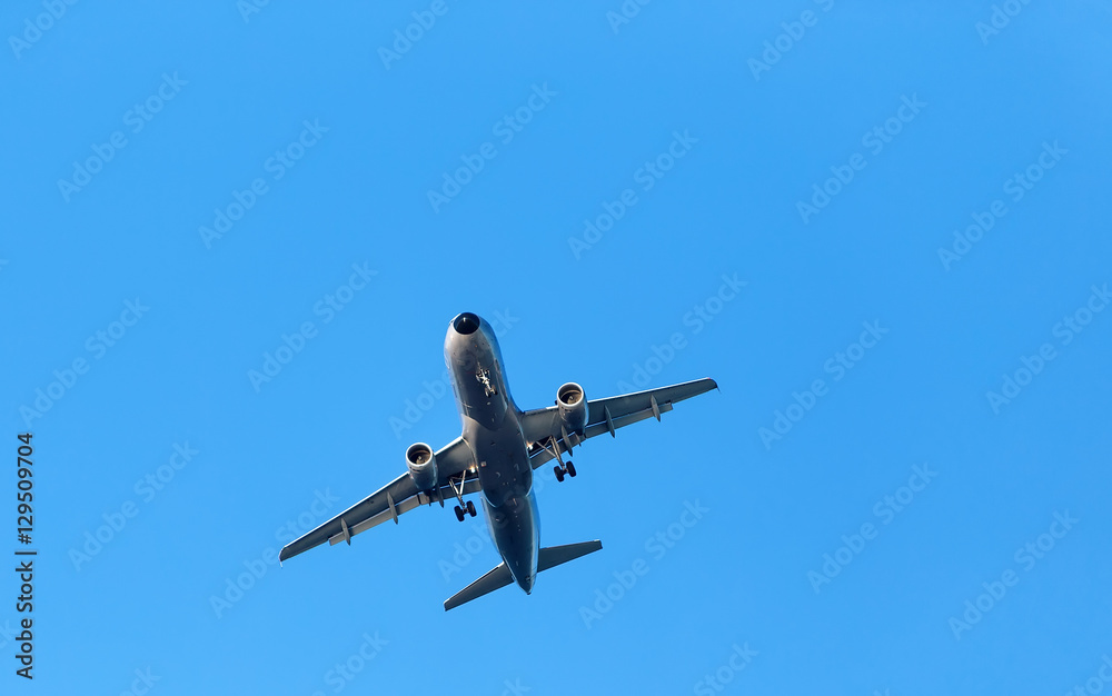 dark silhouette of airplane flying over blue skies dark silhouette of airplane flying over blue skies