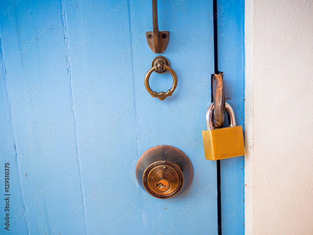 A key lock on a wooden blue door