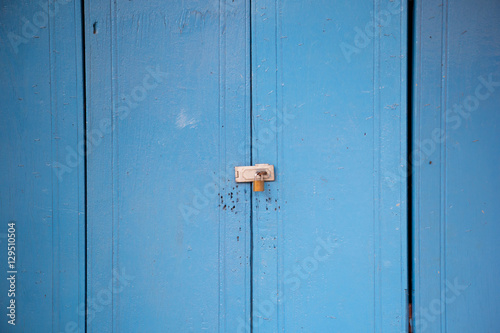A key lock on a wooden blue door