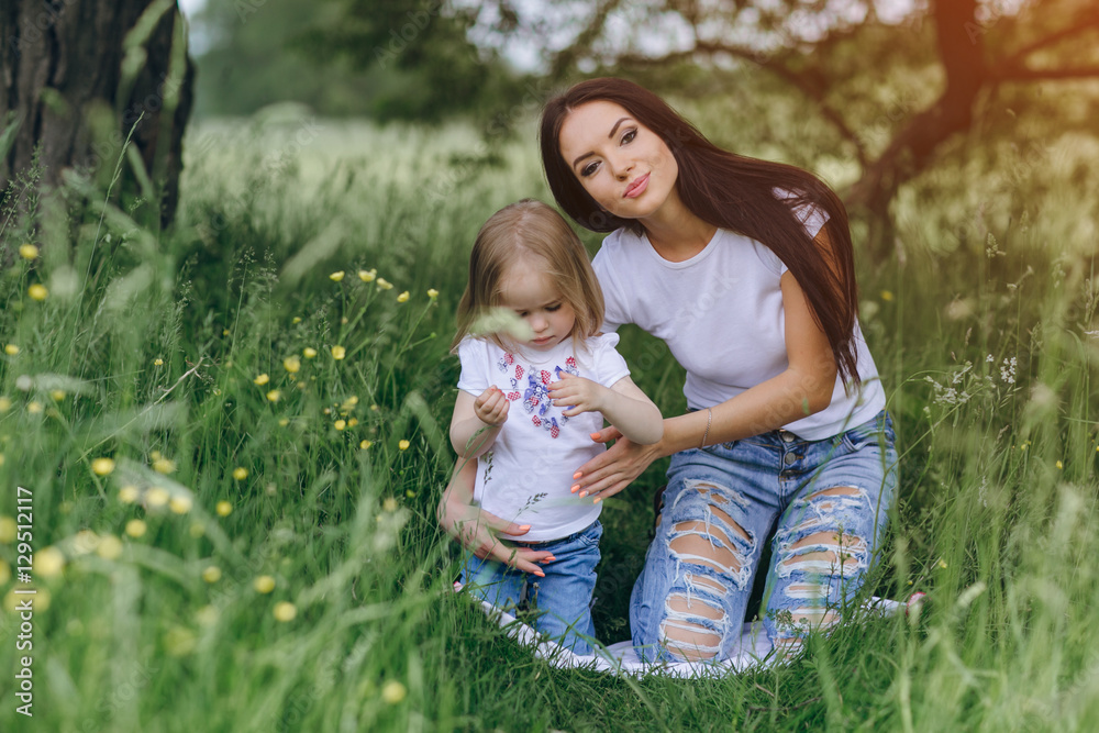 child near tree with mom