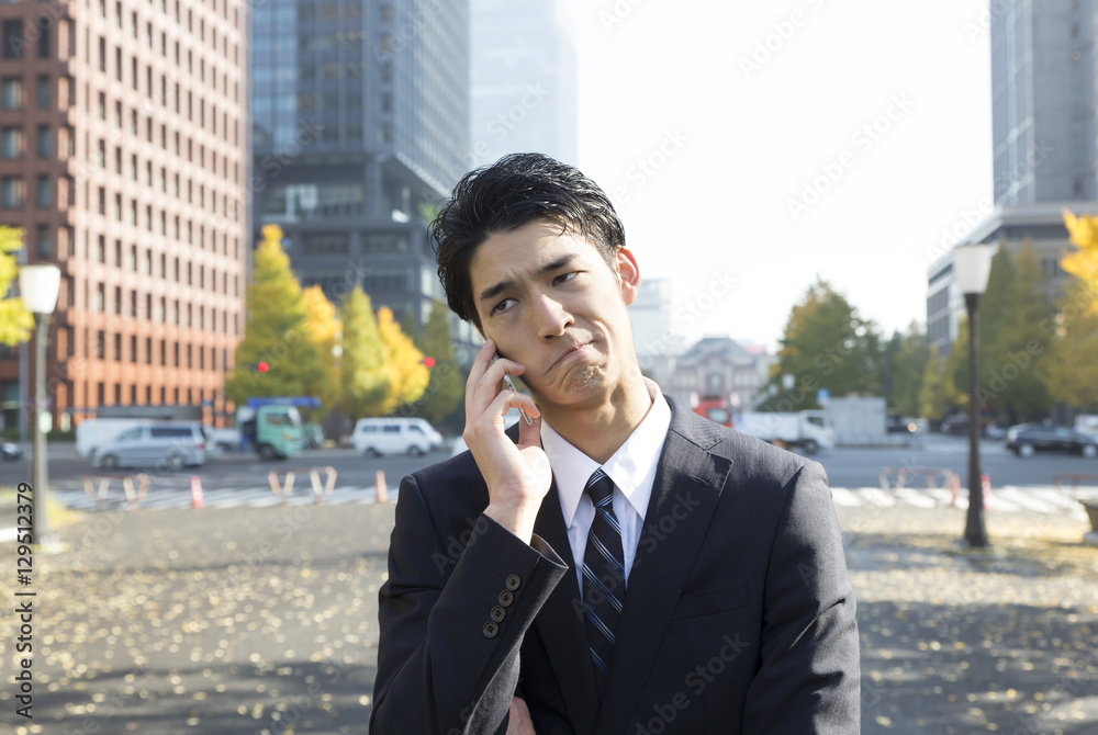 ビジネスマン　スマホ　表情　悩む　考える　困る　外　東京　大手町　丸の内 