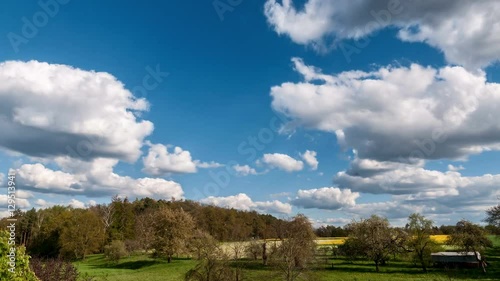 Moving clouds over fields and forest 4K