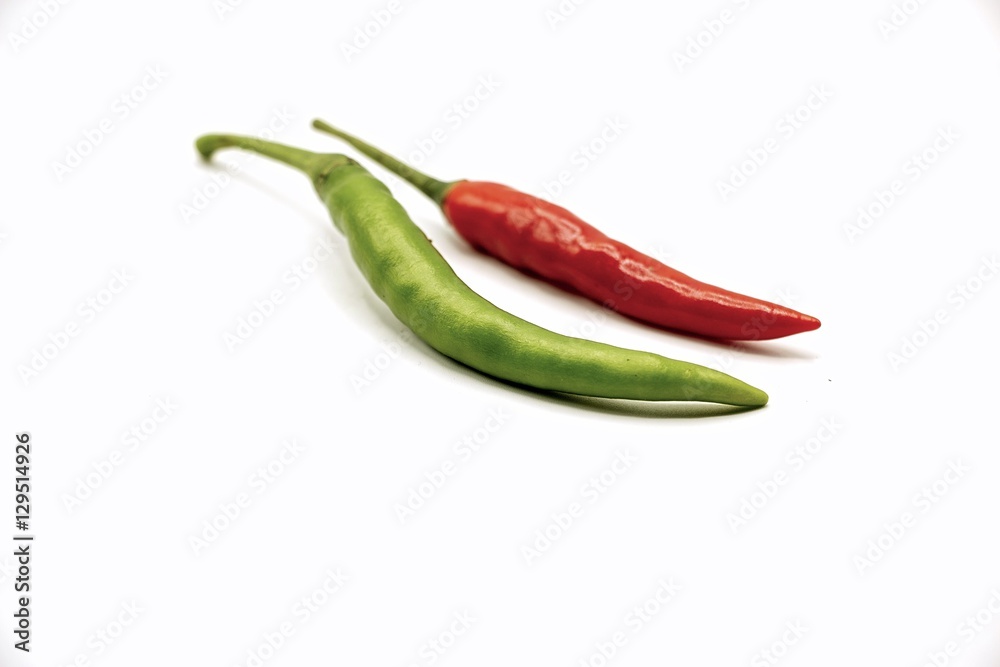 Green and red chilli on white background