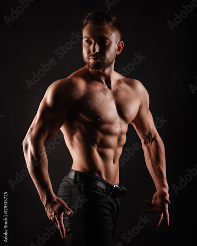 Bodybuilder Posing. Muscles shoulders and press.