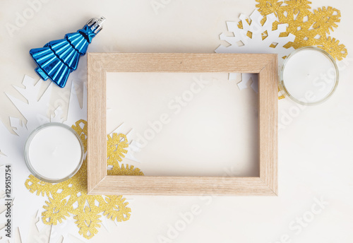 Empty photo frame with christmas tree toy, white and gold snowfl photo