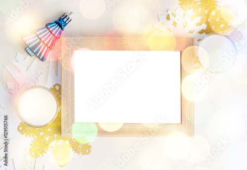 Empty photo frame with christmas tree toy, white and gold snowfl