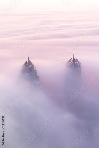 Photography Rare early morning winter fog above the Dubai Marina skyline and skyscrapers ahead of sunrise in Dubai, United Arab Emirates