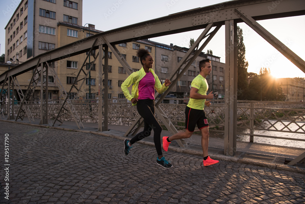 young multiethnic couple jogging in the city