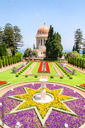 Shrine of Bab in Bahai garden with blossoming flowers in star-form flowerbed before. Haifa, Israel. photo