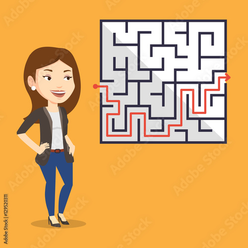 Business woman looking at labyrinth with solution