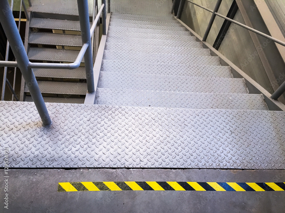 Attention. warning tape yellow and black on a concrete floor. Danger