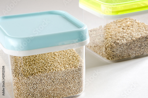 Food storage. Food ingredients (quinoa and wild rice) in plastic containers. Selective focus.