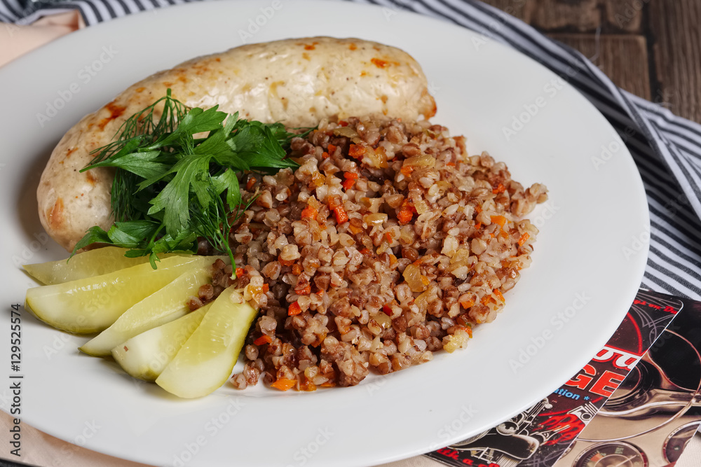 Fototapeta premium Fried homemade sausage with buckwheat and carrot