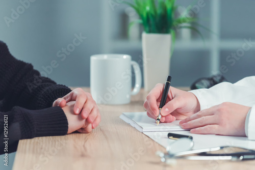 Woman applying for medical exam at female doctor s office