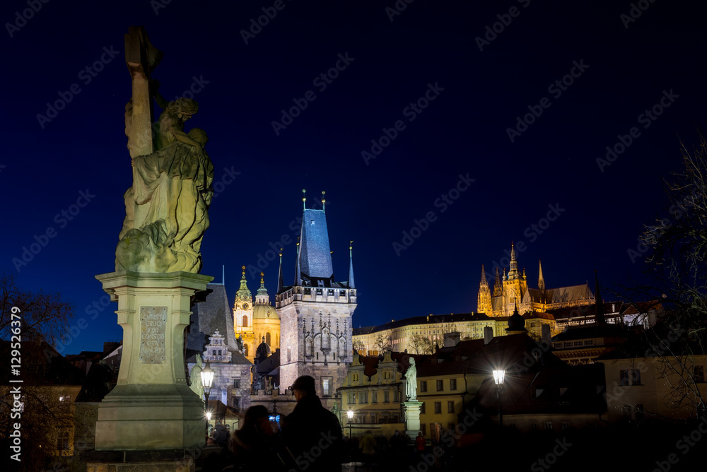 Night photo of Prague Charles Bridge and powder tower
