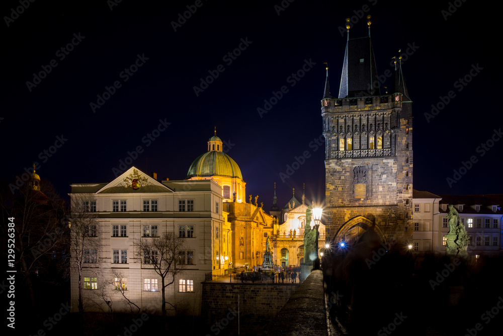 Night photo of Prague Charles Bridge and powder tower