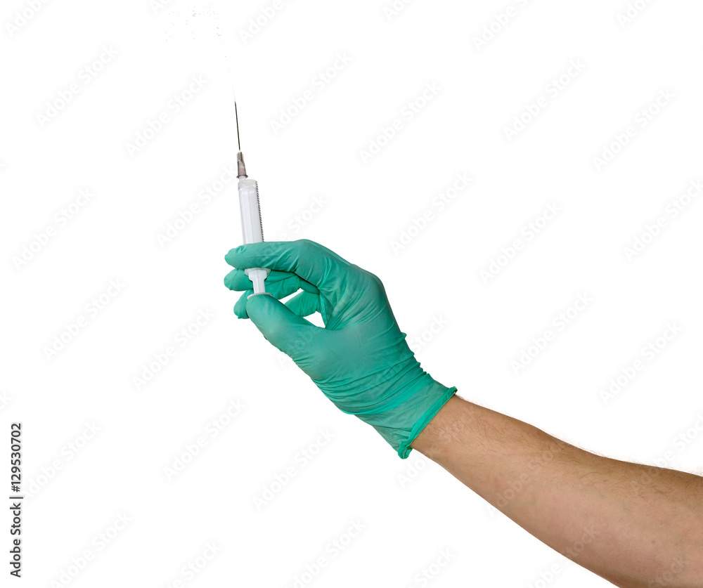 Medical syringe in a male hand wearing a medical glove Medical syringe in a male hand wearing a medical glove