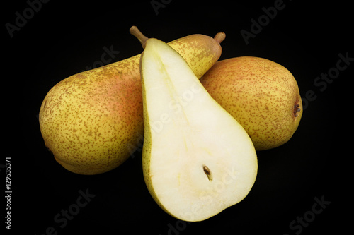 Pears of yellow color on a black background (closeup)