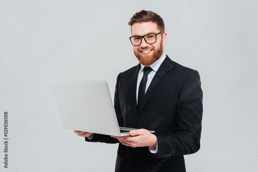 Smiling business man in glasses holding laptop Smiling business man in glasses holding laptop
