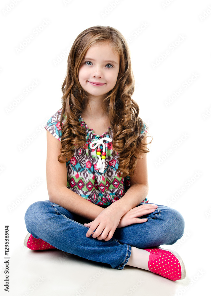 Adorable smiling little girl sitting on a floor isolated Adorable smiling little girl sitting on a floor isolated