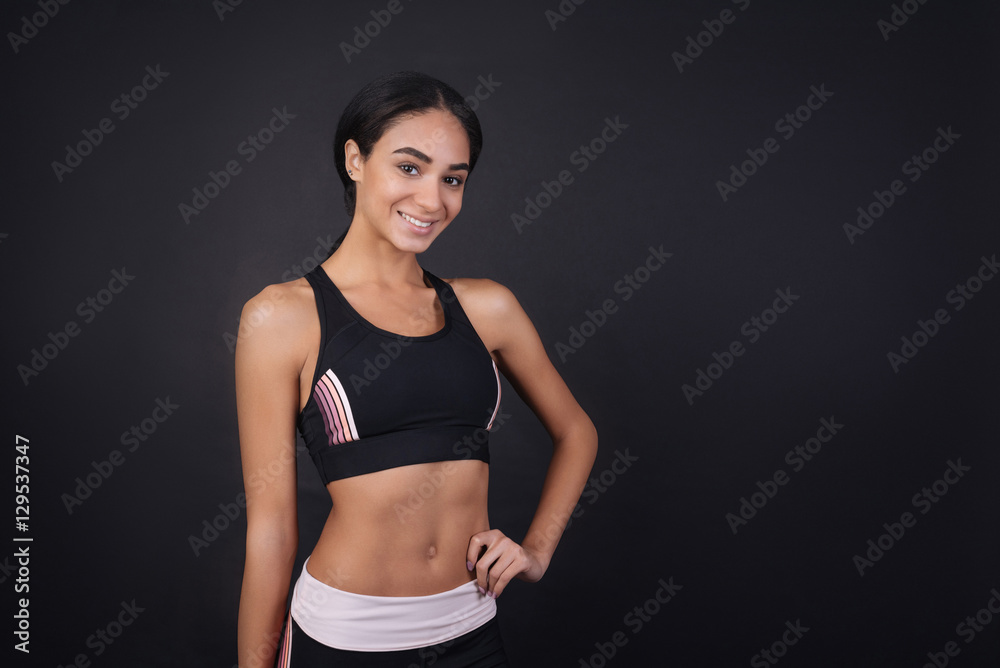 Smiling attractive sportswoman looking at camera Smiling attractive sportswoman looking at camera