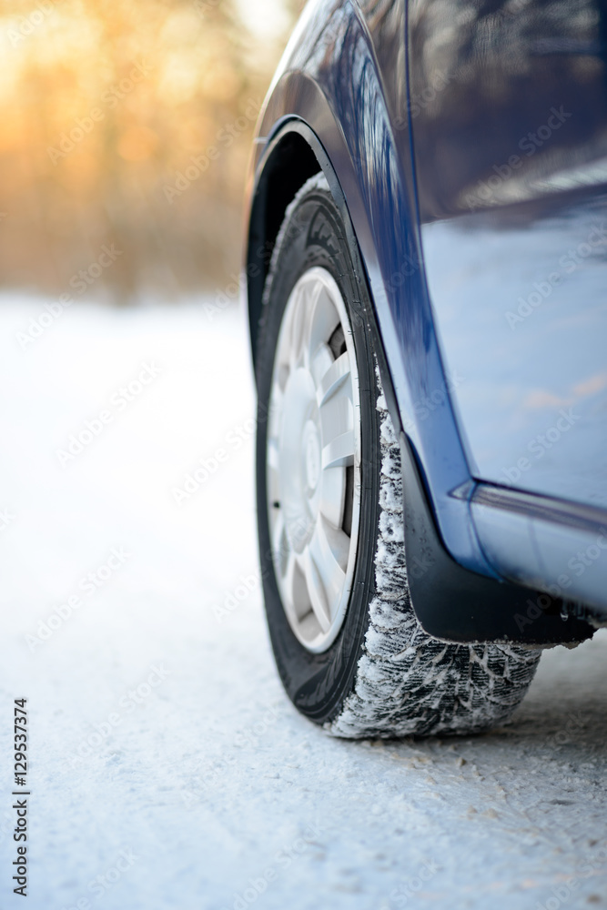 Close-up Image of Winter Car Tire on the Snowy Road. Drive Safe.