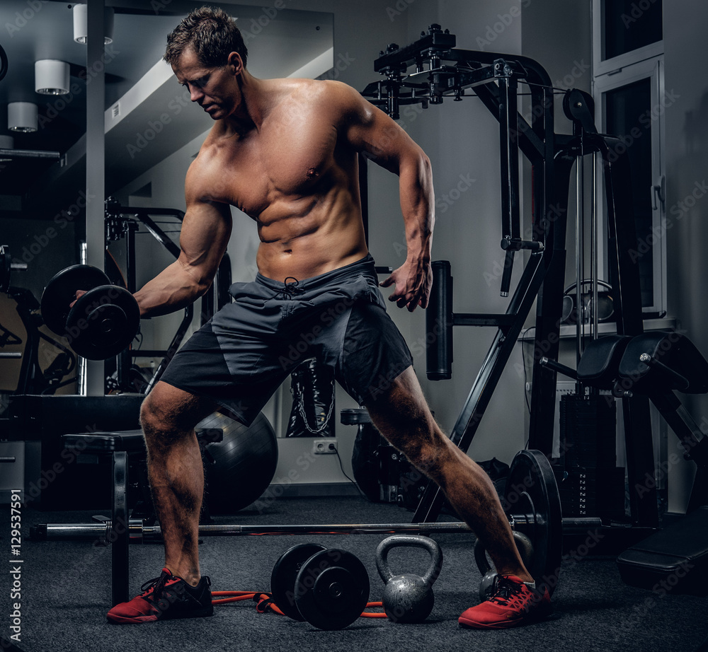 Fototapeta premium Sporty male doing biceps workouts.