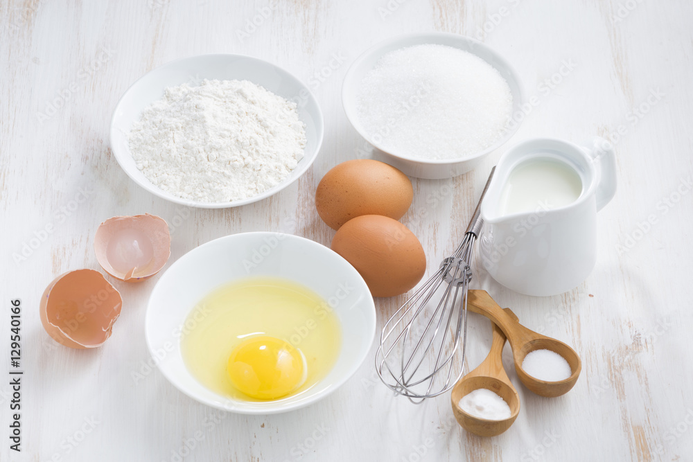 ingredients for baking on a white wooden table, horizontal ingredients for baking on a white wooden table, horizontal
