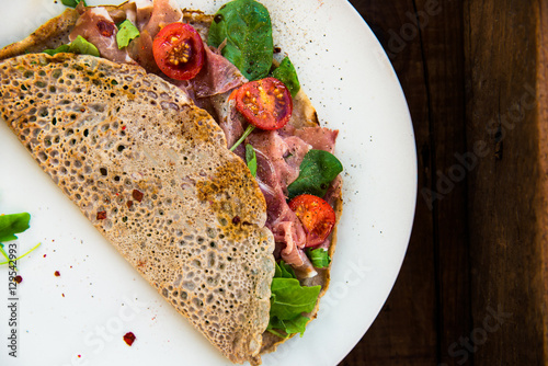 Billede på lærred Buckwheat Pancakes with Cherry Tomatoes, Rocket Salad, Spinach,
